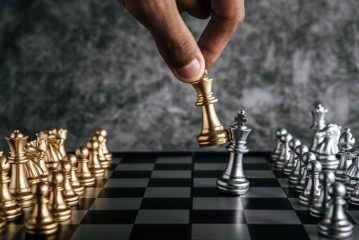 hand-man-playing-chess-business-planning-comparison-metaphor-selective-focus_1150-19606